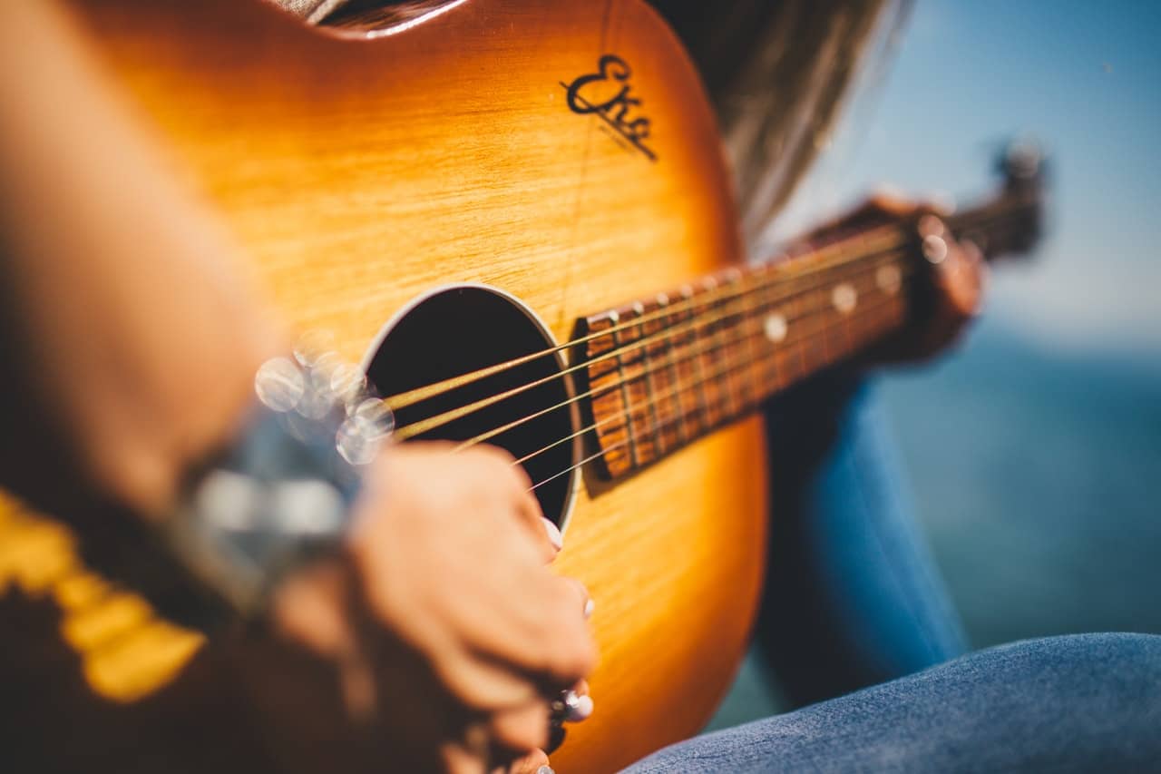 man holding guitars