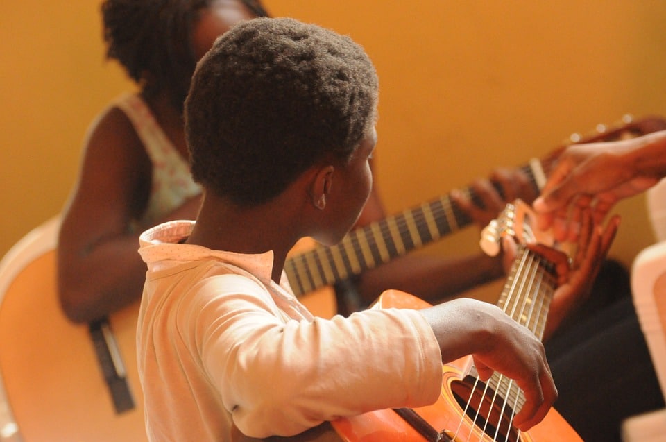 children eager to learn to play guitar
