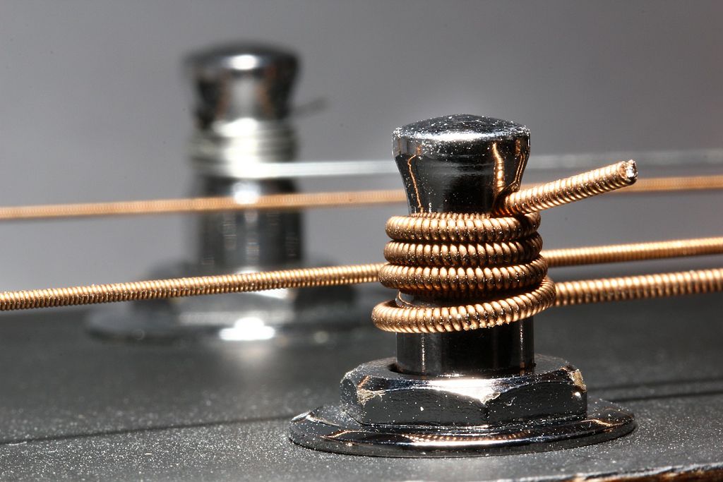 adjusting the set up of Guitar string pegs