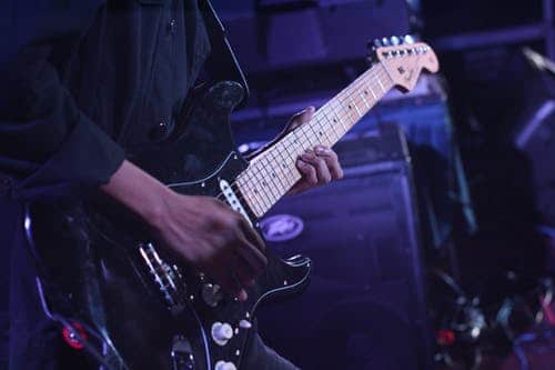 Man playing guitar in stage