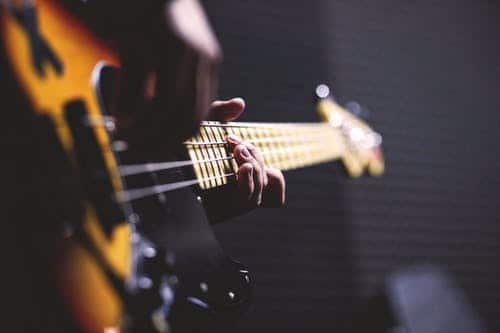 Hands playing guitar string