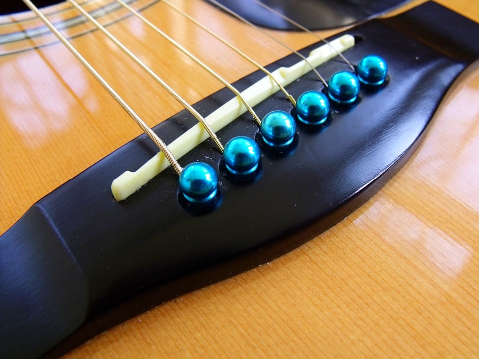 a bridge holding the strings in place on the guitar